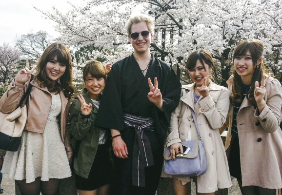 Ein student tek gruppebilde med seg sjølv i midten omgitt av fire japanske kvinner